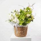 Verdant Ivory Garden white and green floral arrangement in a woven basket