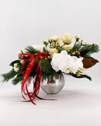 Side view of Winter Grace Arrangement featuring orchids, roses, hydrangeas, and red ribbons