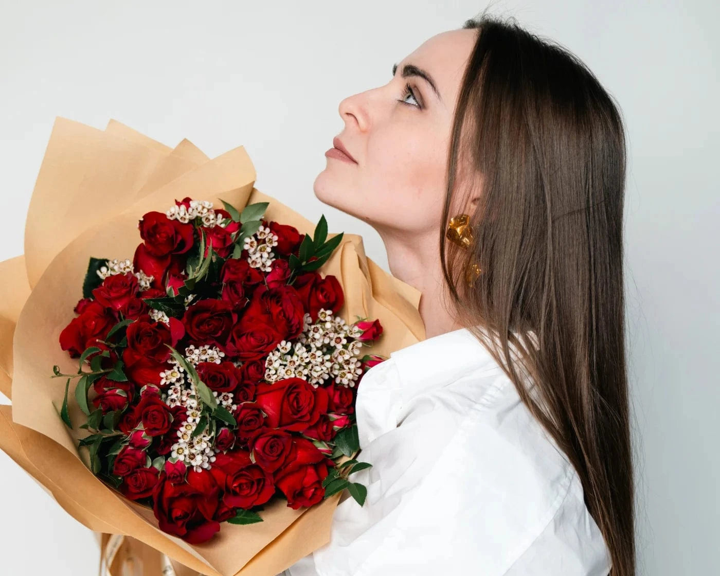 Woman holding a bouquet of red roses with white accent flowers – Flowers Valley San Jose flower delivery