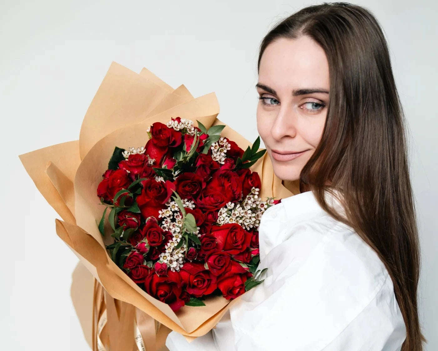 Woman holding a bouquet of red roses with white accent flowers – Flowers Valley Santa Clara flower delivery