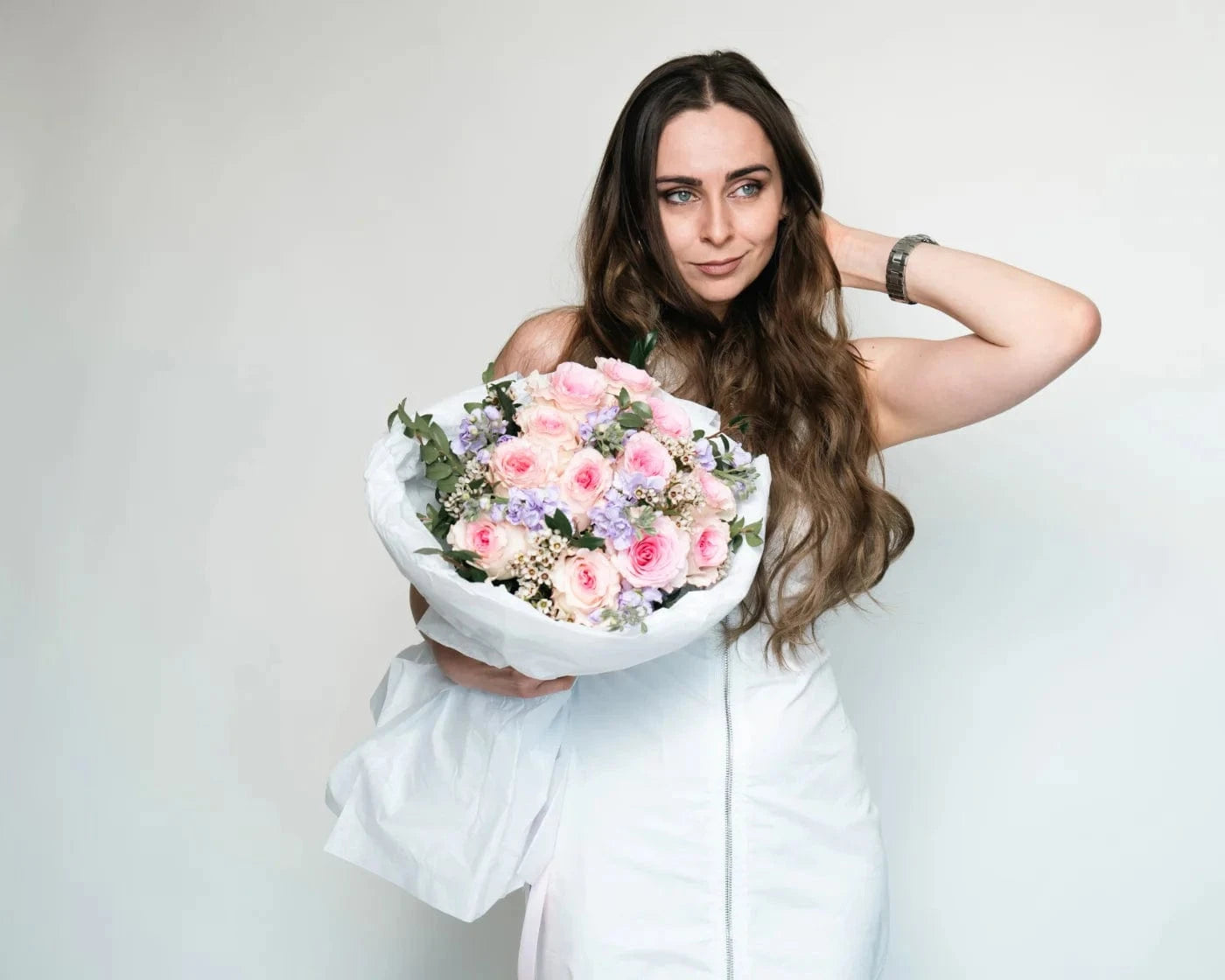 Woman holding a bouquet of pink and white roses with greenery – Flowers Valley Los Gatos flower delivery