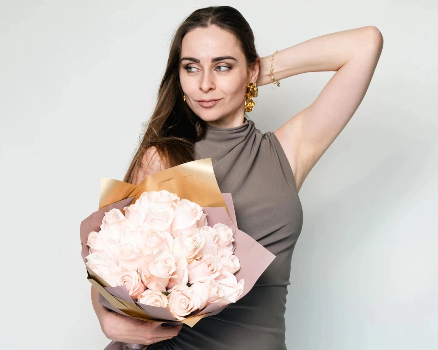 Elegant woman holding a bouquet of white roses wrapped in pastel paper – Flowers Valley Cotati flower delivery