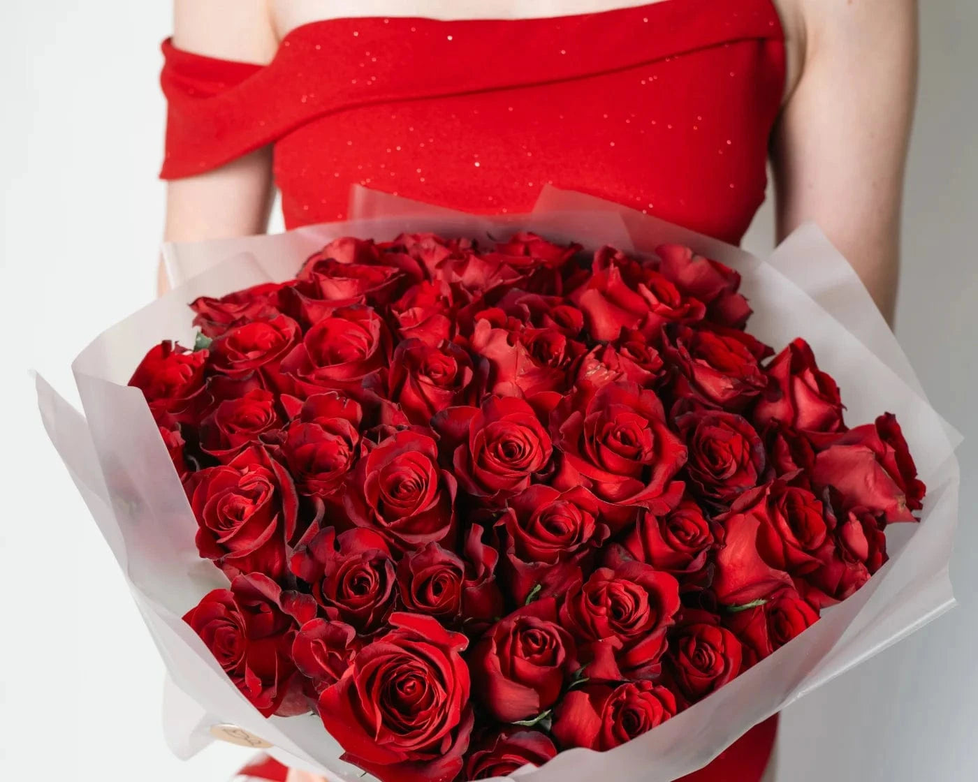 Elegant bouquet of red roses held with a red dress in Yountville – Flowers Valley romantic flower delivery